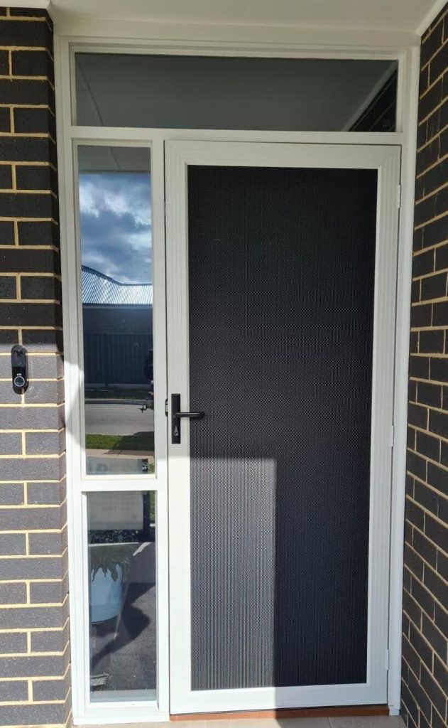 White door featuring a black security screen by Knight Shutters and Improvements.