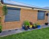 Modern home with Roller shutters Gawler on brick exterior windows