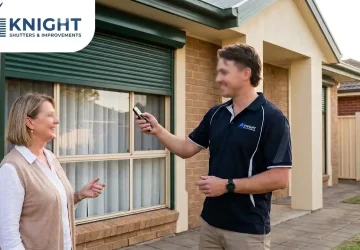 Installer demonstrating an electric roller shutter remote to a homeowner in Adelaide — Knight Shutters