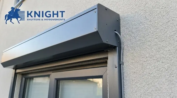 Electric roller shutter motor and guide track mounted above a window