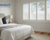 White plantation shutters with louvres partly open in an Adelaide bedroom