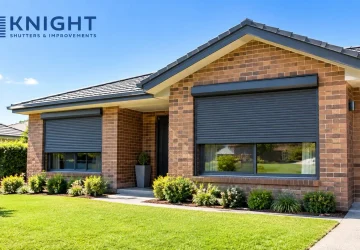 Dark grey roller shutters half lowered on a brick home in Adelaide on a sunny summer morning