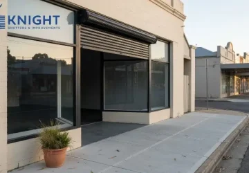 Commercial roller shutter half raised on an Adelaide shopfront