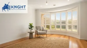 White plantation shutters on a bay window in a bright Adelaide living room