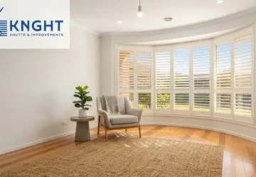 White plantation shutters on a bay window in a bright Adelaide living room