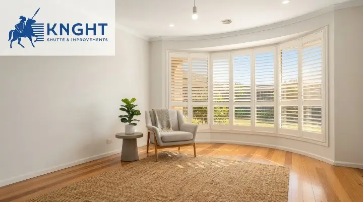 White plantation shutters on a bay window in a bright Adelaide living room