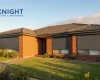 Charcoal roller shutters fitted to the windows of a brick home in Adelaide