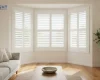 White plantation shutters fitted across a bay window in an Adelaide lounge room