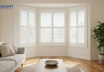White plantation shutters fitted across a bay window in an Adelaide lounge room