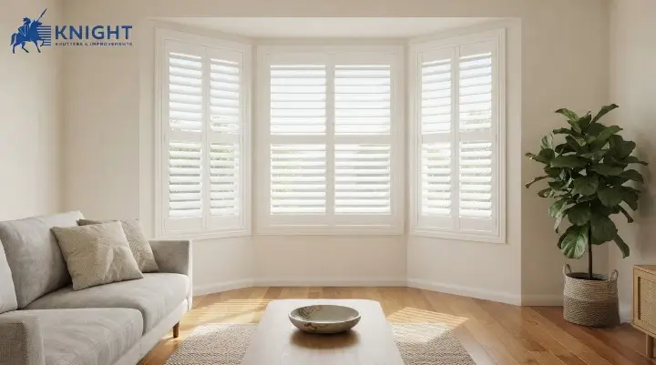 White plantation shutters fitted across a bay window in an Adelaide lounge room
