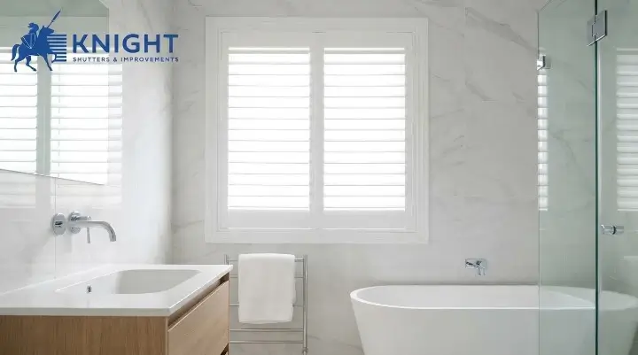 Water-resistant white plantation shutters in a bright bathroom